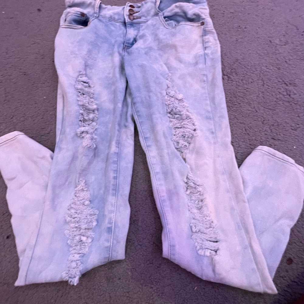 ripped bleached washed blue jeans